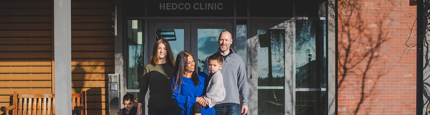 Photo: Family outside of HEDCO Clinic