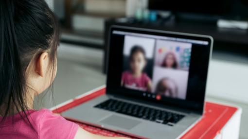 Photo: Child using Zoom on laptop